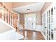 Inviting foyer with hardwood floors, staircase, and glass-paneled french doors at 10580 Saddlestone Dr, Fishers, IN 46040