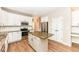 Bright kitchen with white cabinets, stainless steel appliances, granite countertops, and an island at 10580 Saddlestone Dr, Fishers, IN 46040