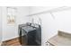 A laundry room with a front-load washer and dryer set and wood look floors at 10580 Saddlestone Dr, Fishers, IN 46040