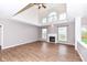 Bright living room with vaulted ceilings, hardwood floors, fireplace, and lots of natural light at 10580 Saddlestone Dr, Fishers, IN 46040