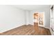 Room with wood look floors, white walls, and a doorway with a glass door at 10580 Saddlestone Dr, Fishers, IN 46040