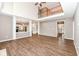 Spacious living room featuring hardwood floors, fireplace, and open access to the kitchen at 10580 Saddlestone Dr, Fishers, IN 46040
