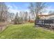 Lush backyard boasts a sprawling lawn, mature trees, and an elevated deck, providing a private retreat at 11789 Langham Crescent Ct, Fishers, IN 46037