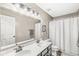 Neutral bathroom with double vanity, large mirror, and shower-tub combo at 11789 Langham Crescent Ct, Fishers, IN 46037
