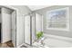 Bright bathroom with a glass shower, soaking tub, and a window at 11789 Langham Crescent Ct, Fishers, IN 46037