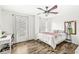 Bedroom featuring hard surface flooring, a ceiling fan, a desk, and two large windows at 11789 Langham Crescent Ct, Fishers, IN 46037