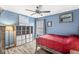 Blue bedroom featuring a bed, ceiling fan, hard surface flooring, and built-in storage at 11789 Langham Crescent Ct, Fishers, IN 46037