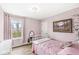 Bedroom with a metal frame bed, pink walls, a window and a chandelier at 11789 Langham Crescent Ct, Fishers, IN 46037