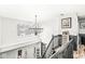 Bright, open foyer featuring staircase, hardwood floors, and a stunning chandelier at 11789 Langham Crescent Ct, Fishers, IN 46037