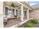 Inviting front porch with comfortable seating, ceiling fans, and stylish columns at 11789 Langham Crescent Ct, Fishers, IN 46037