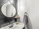 Stylish half-bathroom featuring shiplap wall, granite counters, modern faucet, and decorative flowers at 11789 Langham Crescent Ct, Fishers, IN 46037