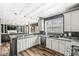 Eat-in kitchen featuring granite counters, stainless appliances, gray cabinets, hardwood floors, and recessed lighting at 11789 Langham Crescent Ct, Fishers, IN 46037