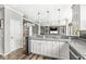 Eat-in kitchen featuring granite counters, white cabinets, stainless appliances, hardwood floors, and recessed lighting at 11789 Langham Crescent Ct, Fishers, IN 46037