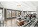 Bright, open-concept living room featuring a large sectional sofa, hardwood floors, and a stunning decorative ceiling at 11789 Langham Crescent Ct, Fishers, IN 46037