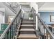 Staircase featuring dark trim, wooden steps, decorative art, and plants at 11789 Langham Crescent Ct, Fishers, IN 46037