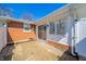 Back patio with brick pavers, access to the backyard and an exterior view of the home at 1219 Fairfax St, Anderson, IN 46012