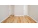 Bedroom features light hardwood floors, two doors, and neutral walls at 1219 Fairfax St, Anderson, IN 46012