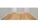 The light hardwood flooring of the bedroom complement the neutral wall colors at 1219 Fairfax St, Anderson, IN 46012