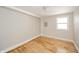 Bedroom features light hardwood flooring and a window bringing in natural light at 1219 Fairfax St, Anderson, IN 46012
