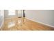 Bright living room featuring hardwood floors, neutral paint, and access to the kitchen at 1219 Fairfax St, Anderson, IN 46012