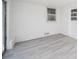 Bright sunroom with white-painted brick walls, wood-look floors, and plenty of natural light at 1219 Fairfax St, Anderson, IN 46012