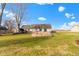 Large backyard with a wood deck, storage shed, and plenty of grassy space at 1243 S Morristown Pike, Greenfield, IN 46140