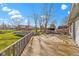 Backyard featuring a spacious wooden deck, lush green grass, and vibrant blue skies at 1243 S Morristown Pike, Greenfield, IN 46140