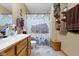 Bathroom featuring dual vanities, barn-themed shower curtain and natural-wood shelving for towels at 1243 S Morristown Pike, Greenfield, IN 46140