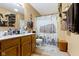 Bathroom featuring wooden vanity, toilet, and shower with barn-themed shower curtain at 1243 S Morristown Pike, Greenfield, IN 46140