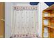 Bathroom with patterned shower curtain, shelving, and ample lighting at 1243 S Morristown Pike, Greenfield, IN 46140