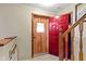 Welcoming entryway featuring wood accents and a vibrant red door, leading to a warm and inviting interior at 1243 S Morristown Pike, Greenfield, IN 46140