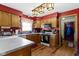 Bright kitchen featuring hardwood floors, oak cabinets, white countertops, and modern appliances at 1243 S Morristown Pike, Greenfield, IN 46140