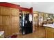 Kitchen with wood cabinets and a stainless steel refrigerator with a door that is covered in notes and reminders at 1243 S Morristown Pike, Greenfield, IN 46140