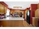 Well-lit kitchen featuring hardwood floors, oak cabinets, white countertops, and black appliances at 1243 S Morristown Pike, Greenfield, IN 46140