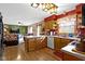 An open kitchen includes wood cabinets, white countertops, stainless steel appliances, and a breakfast bar overlooking the living room at 1243 S Morristown Pike, Greenfield, IN 46140