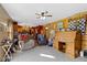 A comfortable living room with a ceiling fan, natural light, and wooden walls, with the kitchen in the background at 1243 S Morristown Pike, Greenfield, IN 46140