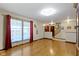 Bright living room featuring hardwood floors, large windows with curtains, and staircase to the upper level at 1243 S Morristown Pike, Greenfield, IN 46140