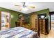 Well-decorated primary bedroom offering wood floors, a ceiling fan, and an ensuite bathroom at 1243 S Morristown Pike, Greenfield, IN 46140