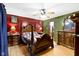 Cozy primary bedroom with hardwood floors, ceiling fan, and full wooden furniture set at 1243 S Morristown Pike, Greenfield, IN 46140