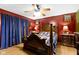Cozy primary bedroom featuring hardwood floors, ceiling fan, and full wooden furniture set at 1243 S Morristown Pike, Greenfield, IN 46140