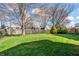 Green backyard with lush lawn, mature trees, and a wooden fence, creating a serene and private outdoor space at 12702 Slippery Rock Rd, Indianapolis, IN 46236