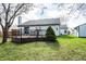 Inviting backyard with deck, lush green lawn, mature trees, and storage shed, ideal for entertaining at 12702 Slippery Rock Rd, Indianapolis, IN 46236