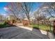 Charming backyard featuring a wooden deck, concrete patio, and well-maintained lawn, perfect for outdoor relaxation at 12702 Slippery Rock Rd, Indianapolis, IN 46236