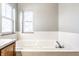 A bright bathroom with white tiled tub and dual windows at 12702 Slippery Rock Rd, Indianapolis, IN 46236