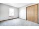 A gray bedroom with sliding closet door and soft gray carpet flooring at 12702 Slippery Rock Rd, Indianapolis, IN 46236