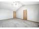 A spacious gray bedroom with two wood doors and soft gray carpet flooring at 12702 Slippery Rock Rd, Indianapolis, IN 46236