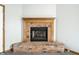 Close up view of a brick fireplace with wood mantle and hearth at 12702 Slippery Rock Rd, Indianapolis, IN 46236