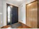 Inviting foyer with hardwood floors, a black front door, and neutral gray walls at 12702 Slippery Rock Rd, Indianapolis, IN 46236