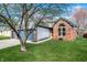 Charming two-story brick home with attached two car garage and a well-manicured front lawn at 12702 Slippery Rock Rd, Indianapolis, IN 46236