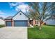 Charming two-story brick and siding home with attached two car garage and a well-manicured front lawn at 12702 Slippery Rock Rd, Indianapolis, IN 46236